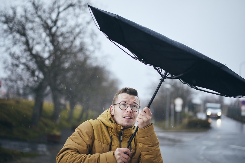 an with umbrella in wind and rain